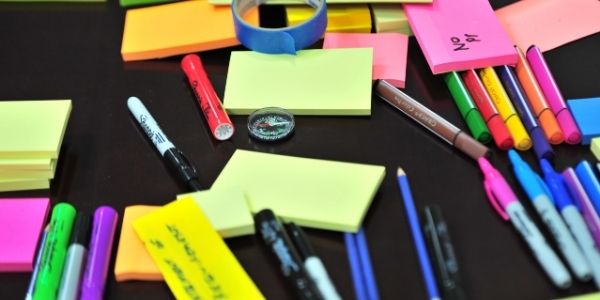 Stationery items including pens, sticky notes, markers, etc. Material needed to study UPSC Mains Syllabus PDF.